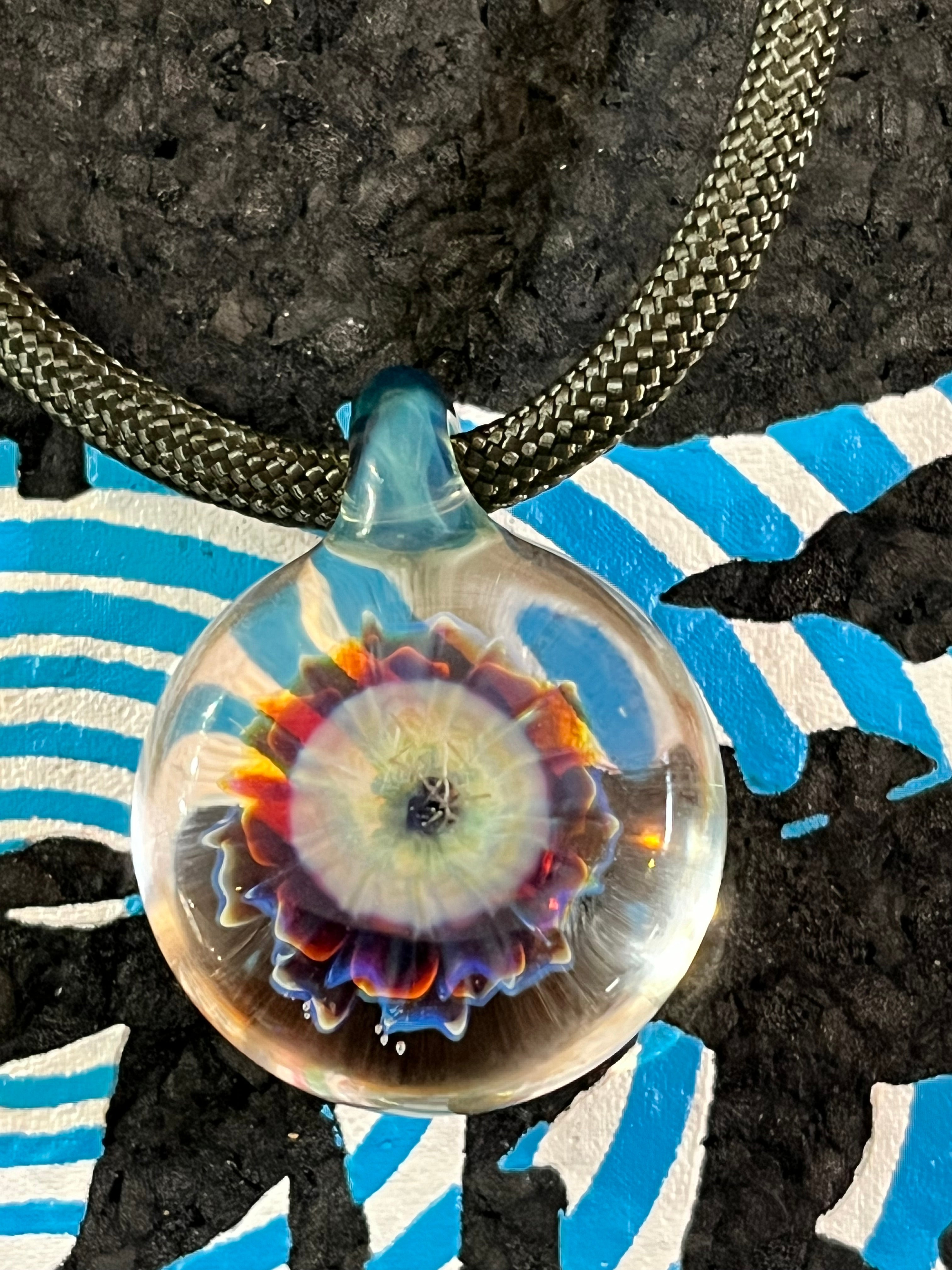 Roe Glass Flower Implosion pendant with handcrafted vibrant petals, unique jewelry piece capturing nature’s elegance and artistry.