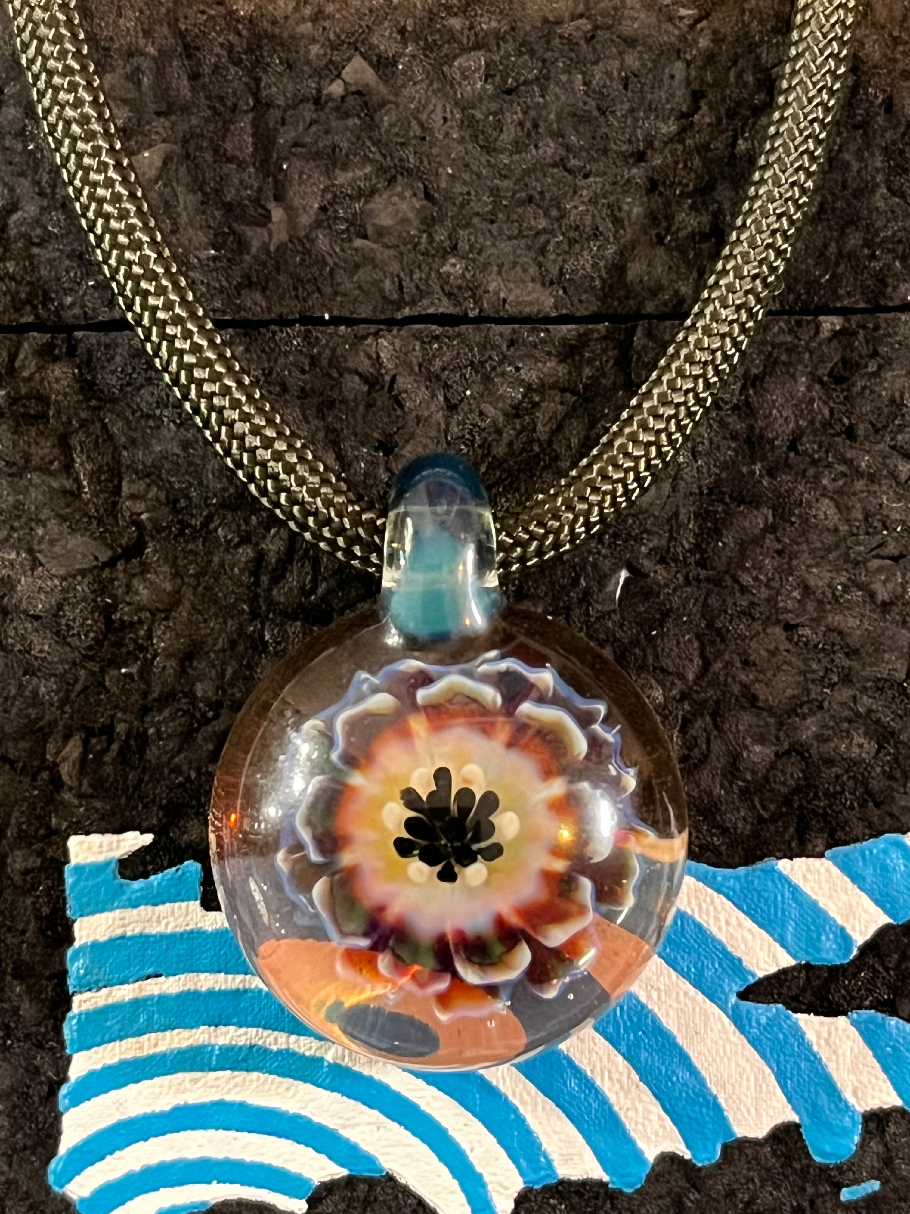 Close-up of Roe Glass Flower Implosion pendant showing vibrant handcrafted petals and intricate glass artistry.