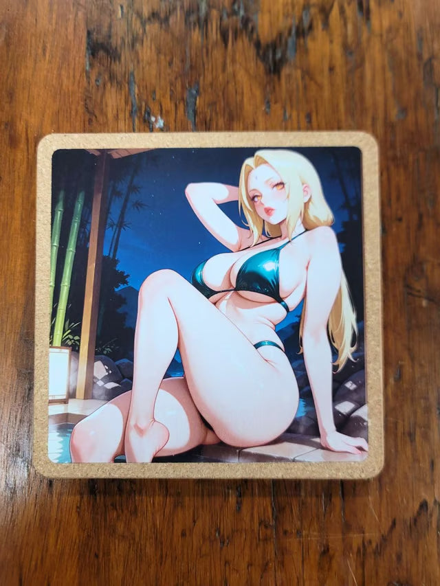 A square printed coaster or tile with rounded corners, featuring an anime-style illustration of a blonde woman in a dark teal bikini sitting at night, placed on a brown wooden surface.