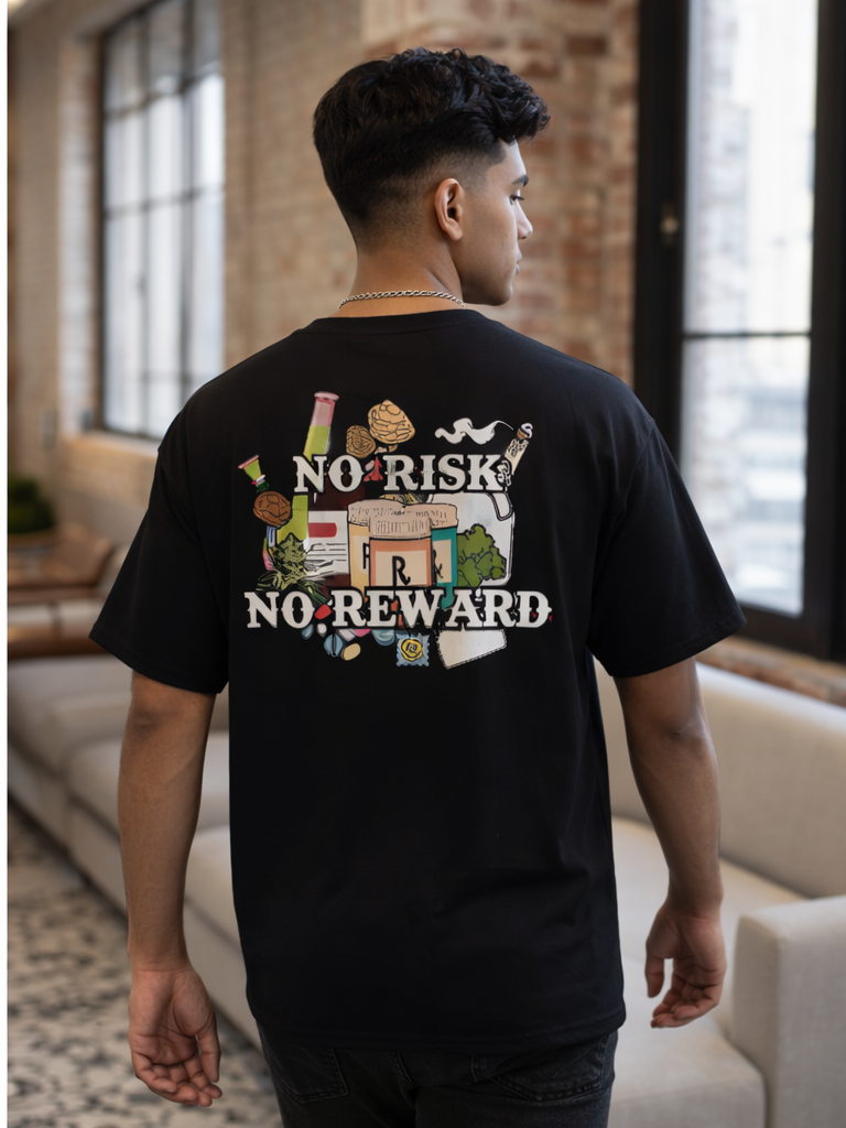 Rear view of man wearing a black No Apologies x The 631 Gallery unisex tee featuring the ‘No Risk No Reward’ back graphic in a loft-style space.