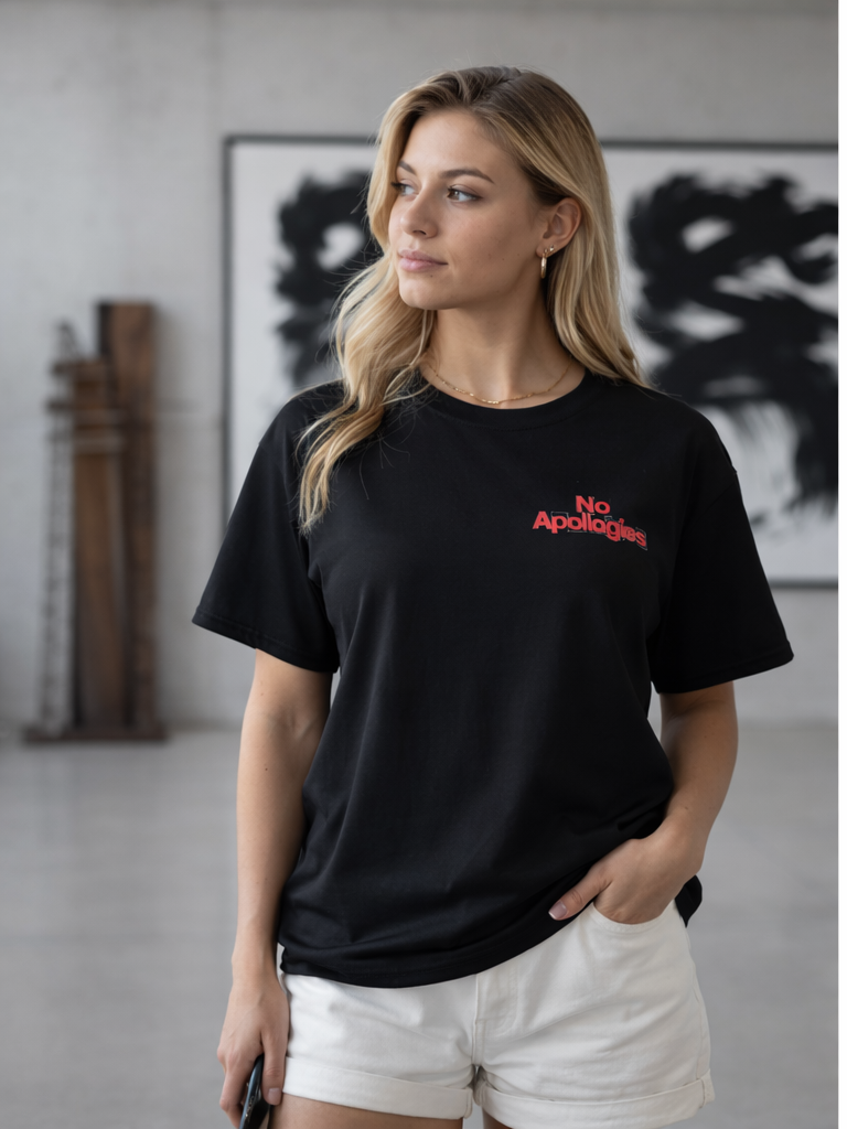 Woman wearing a black No Apologies x The 631 Gallery unisex tee with red chest logo in a modern gallery setting
